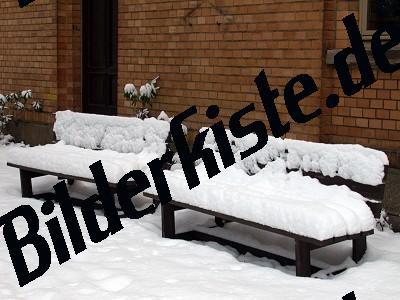 Park bench covered with snow