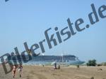 Passenger ship behind beach