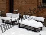 Park bench covered with snow