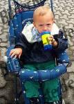 Child in a buggy drinking
